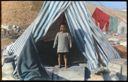 Image of Eskimo [Inuk] Boy at Entrance of Tent